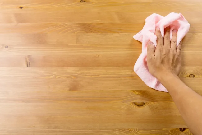 Cleaning table by pink rag